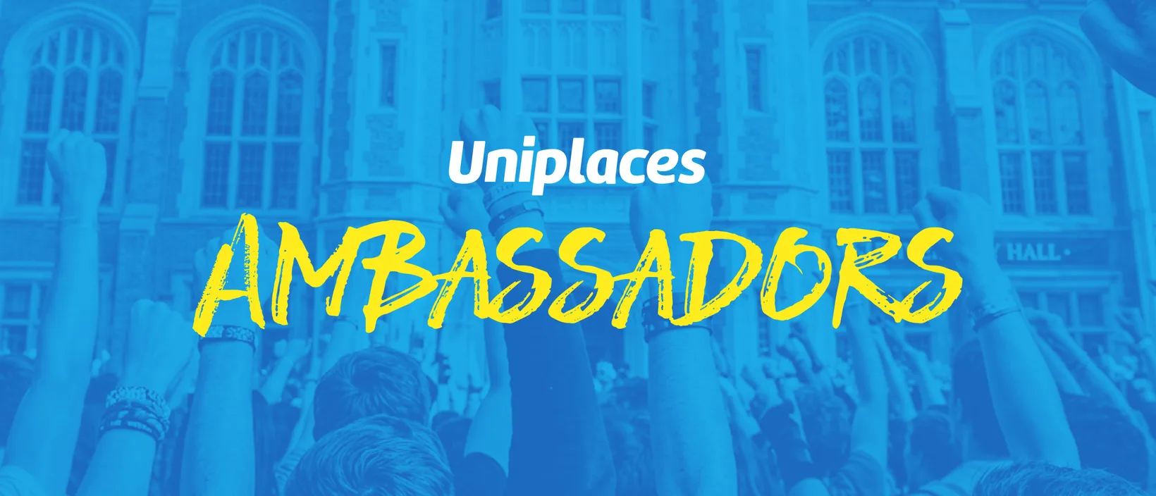 A crowd of students with their arms raised outside a university hall, under the Uniplaces Ambassadors title.